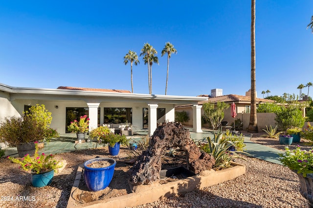 rear view of house with outdoor lounge area and a patio