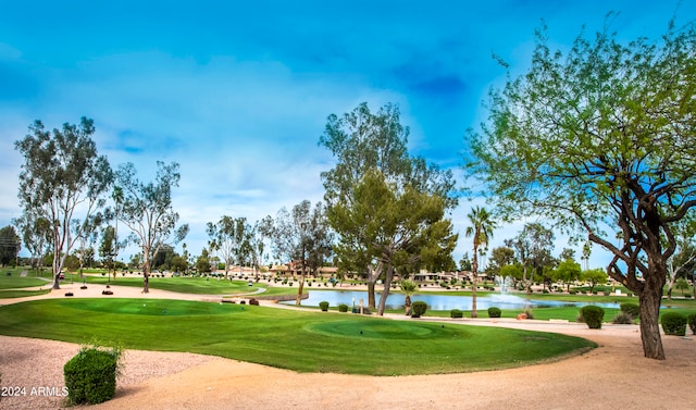 view of property's community with a water view and a yard