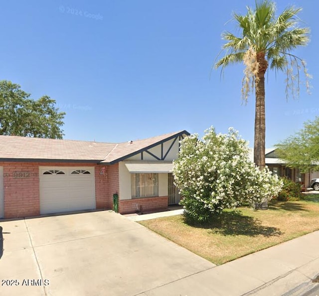 view of front of home with a front lawn and a garage