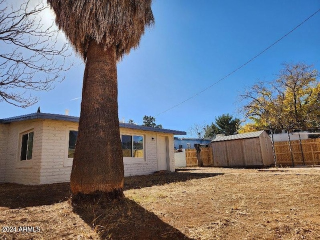 exterior space with a shed