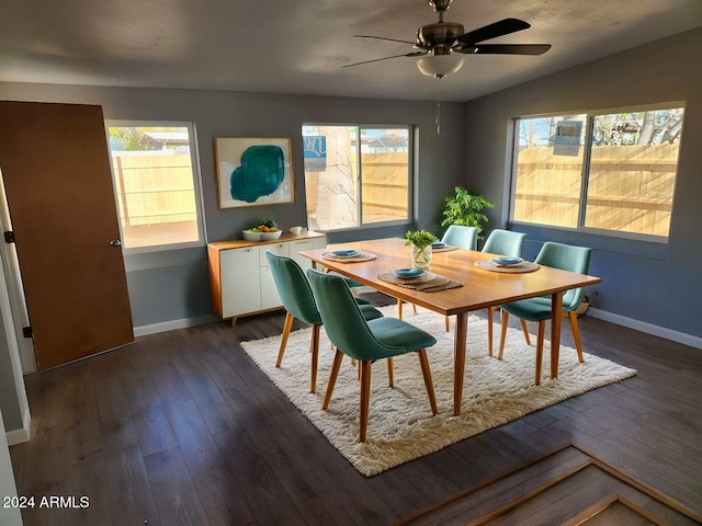 dining area featuring vaulted ceiling, a wealth of natural light, ceiling fan, and dark hardwood / wood-style floors