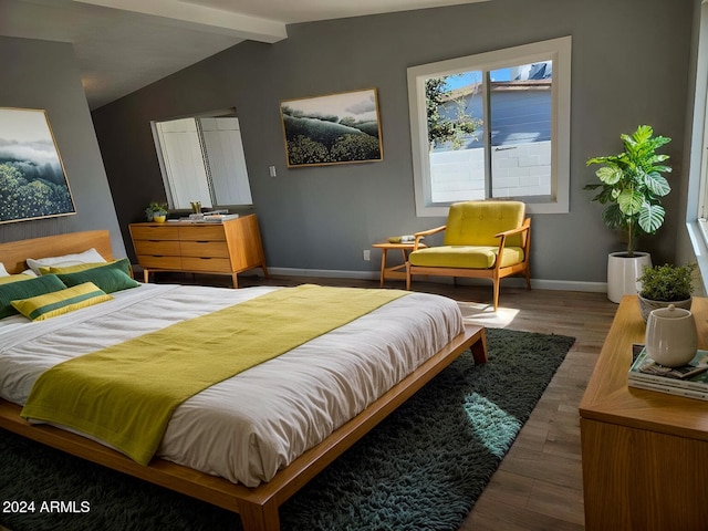 bedroom featuring lofted ceiling with beams and wood-type flooring