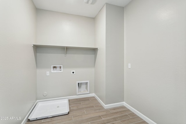 5815 E Covey Ln, Phoenix, AZ 85054 - washroom featuring wood finish floors, electric dryer hookup, baseboards, washer hookup, and hookup for a gas dryer