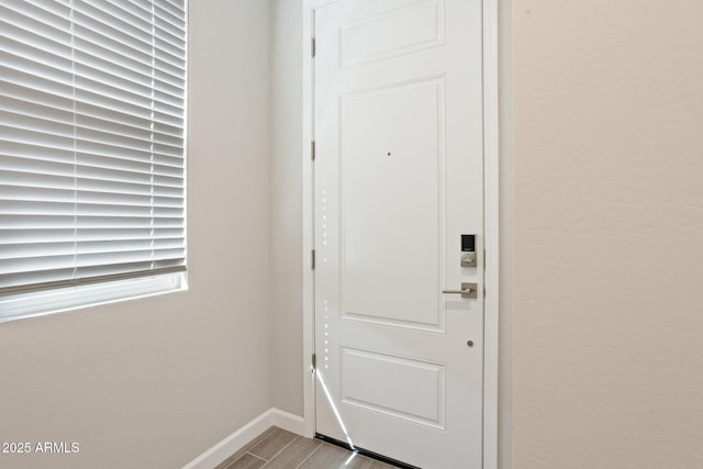 5815 E Covey Ln, Phoenix, AZ 85054 - entryway featuring baseboards and wood finished floors