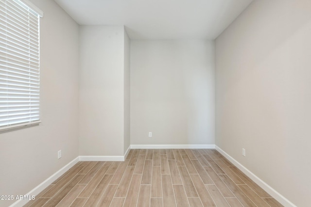 5815 E Covey Ln, Phoenix, AZ 85054 - empty room with light wood-style floors and baseboards