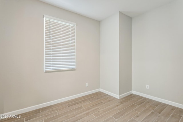 5815 E Covey Ln, Phoenix, AZ 85054 - spare room with light wood-type flooring and baseboards