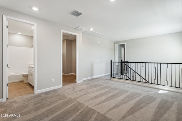 5815 E Covey Ln, Phoenix, AZ 85054 - spare room featuring light colored carpet, baseboards, and recessed lighting