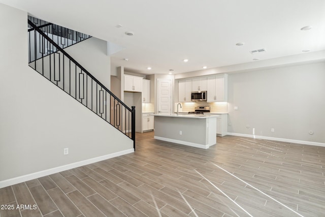 5815 E Covey Ln, Phoenix, AZ 85054 - living area featuring baseboards, light wood finished floors, recessed lighting, and stairway