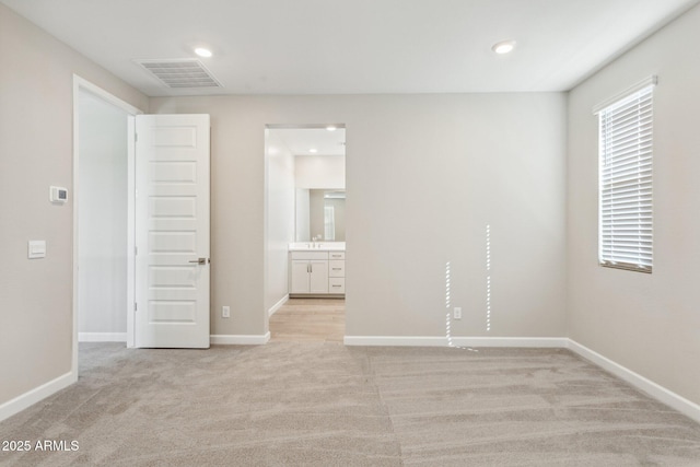5815 E Covey Ln, Phoenix, AZ 85054 - spare room featuring light carpet, baseboards, and recessed lighting