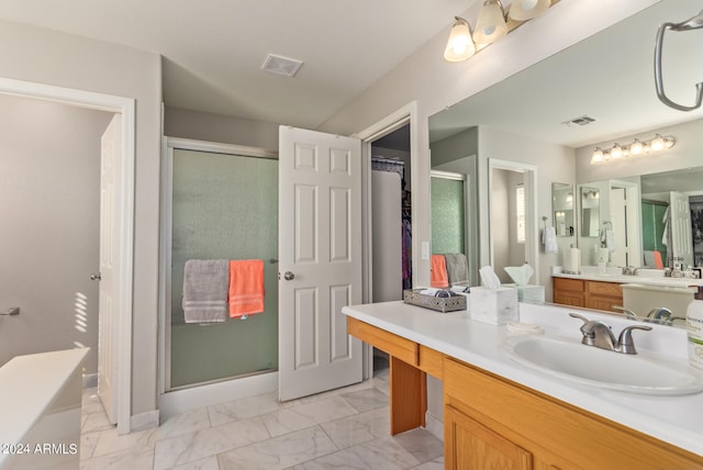 bathroom with vanity and a shower with door