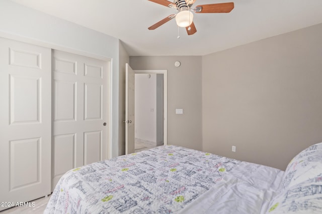 bedroom featuring ceiling fan and a closet