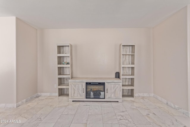 unfurnished living room with built in shelves