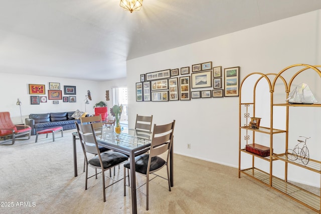 dining room featuring light carpet