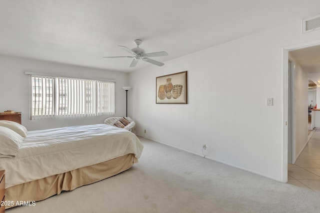 bedroom with ceiling fan and light colored carpet