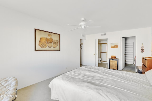 bedroom with ensuite bath, carpet floors, and ceiling fan