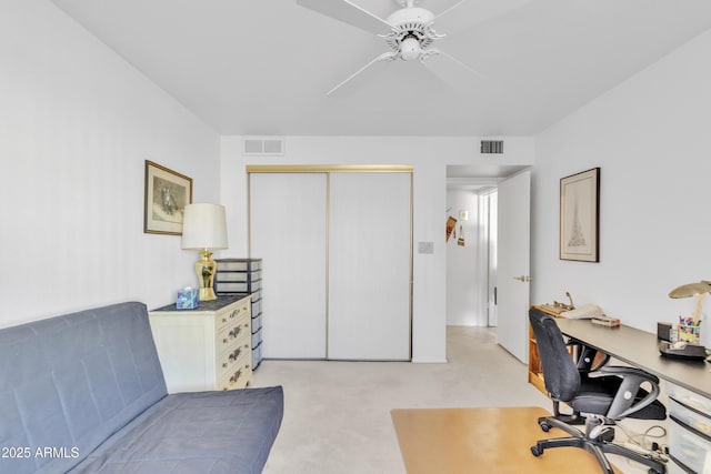 carpeted office with ceiling fan