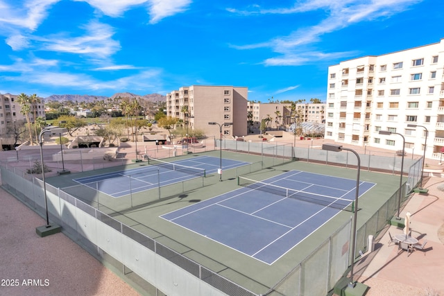 view of tennis court with a mountain view