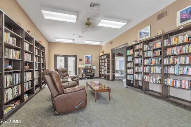 living area featuring carpet and french doors