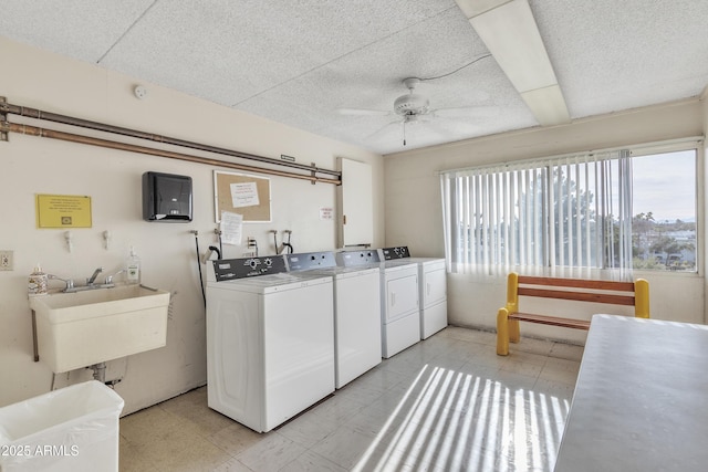 laundry area featuring separate washer and dryer, sink, and ceiling fan