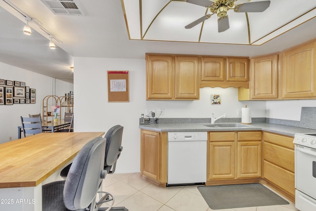 kitchen featuring white appliances, light brown cabinetry, sink, and light tile patterned floors