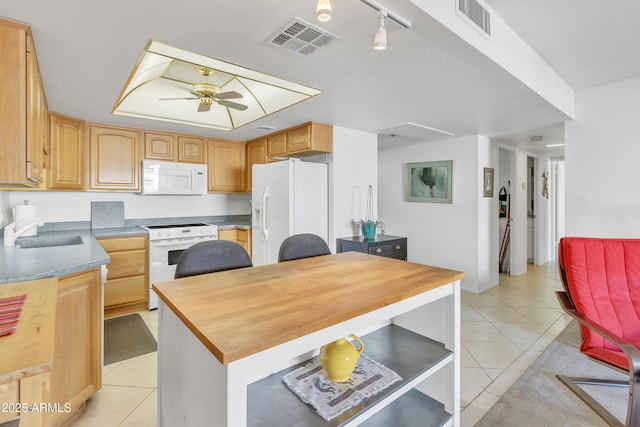 kitchen with light tile patterned floors, white appliances, sink, ceiling fan, and light brown cabinetry