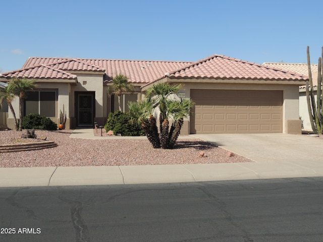 15104 W Pinehurst Ln W, Surprise, AZ 85374 - mediterranean / spanish home with a garage, a tiled roof, concrete driveway, and stucco siding
