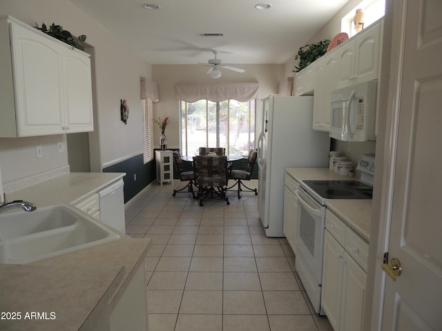 15104 W Pinehurst Ln W, Surprise, AZ 85374 - kitchen featuring white appliances, white cabinets, a sink, and light tile patterned flooring