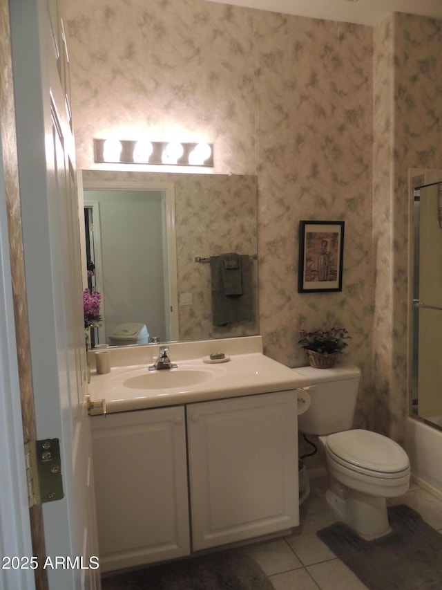 15104 W Pinehurst Ln W, Surprise, AZ 85374 - bathroom featuring toilet, tile patterned floors, vanity, and wallpapered walls