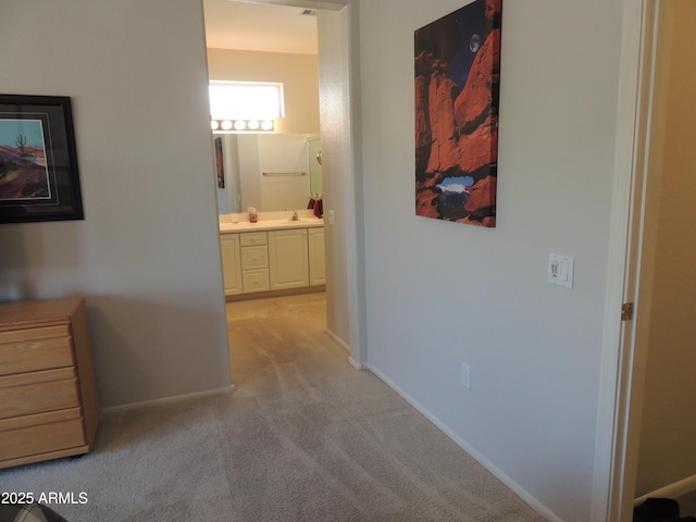 15104 W Pinehurst Ln W, Surprise, AZ 85374 - hallway featuring light colored carpet, a sink, and baseboards