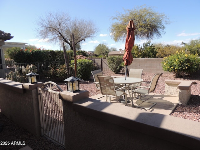 15104 W Pinehurst Ln W, Surprise, AZ 85374 - view of patio / terrace with outdoor dining space, a gate, and a fenced backyard