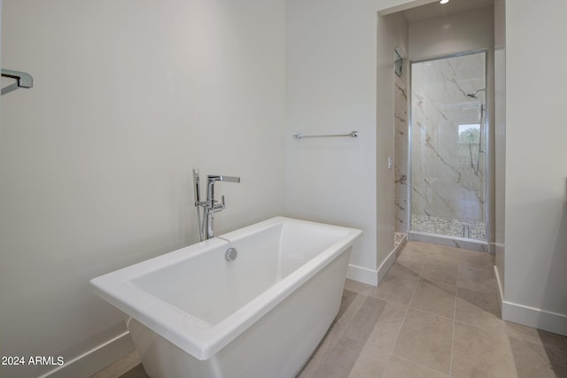 bathroom featuring tile patterned flooring, sink, and shower with separate bathtub