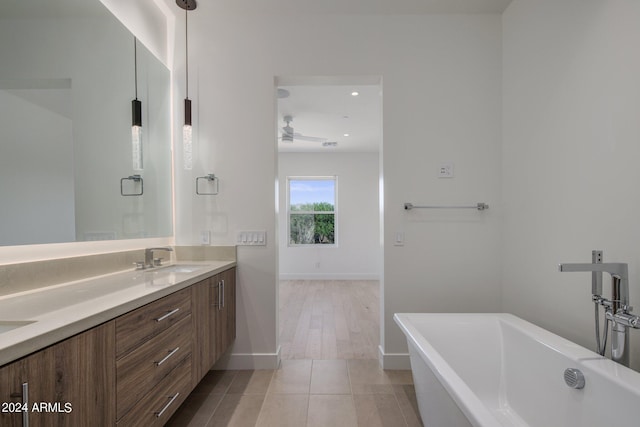 bathroom with tile patterned floors, ceiling fan, vanity, and shower with separate bathtub