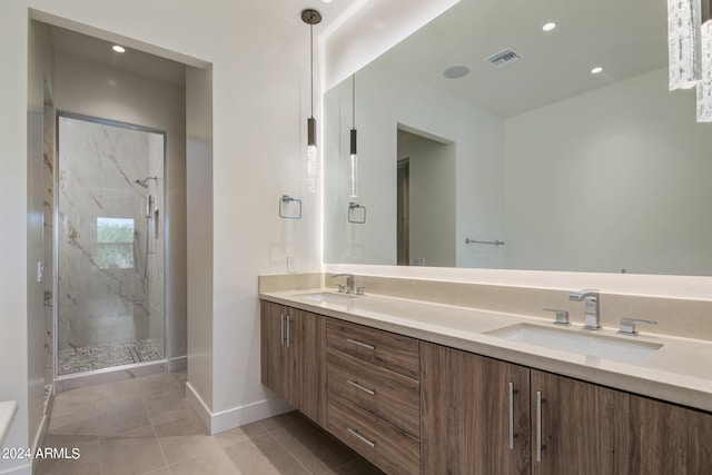 bathroom with tile patterned flooring, vanity, and an enclosed shower