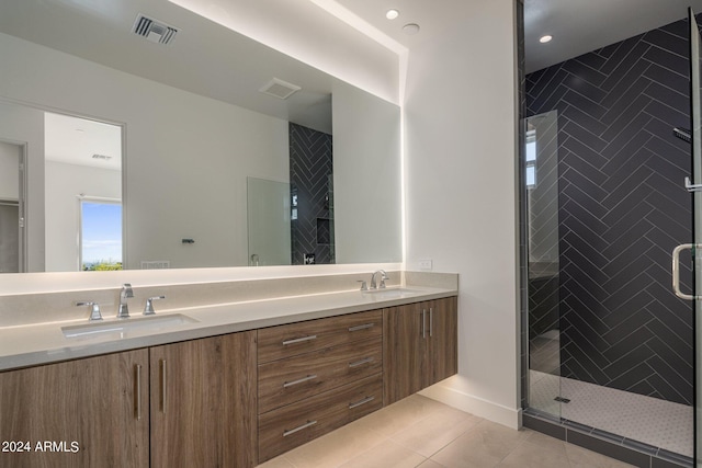 bathroom featuring tile patterned flooring, vanity, and walk in shower