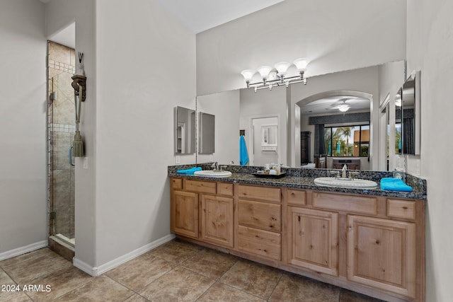 bathroom featuring vanity, a shower with shower door, and tile patterned floors