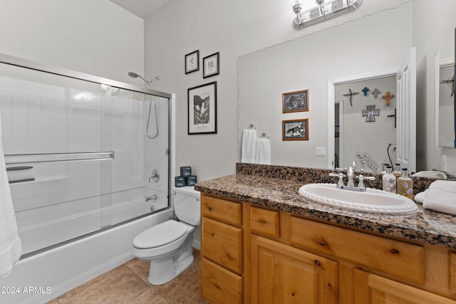 full bathroom featuring shower / bath combination with glass door, vanity, toilet, and tile patterned floors