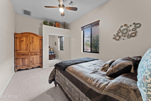 bedroom featuring a closet, ceiling fan, and light colored carpet