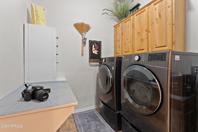 clothes washing area featuring washer and clothes dryer, cabinets, and tile patterned floors