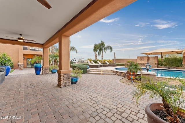 view of patio / terrace featuring ceiling fan and a pool with hot tub