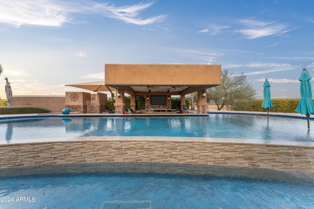 view of swimming pool featuring ceiling fan