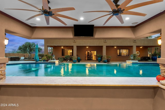 pool at dusk with ceiling fan