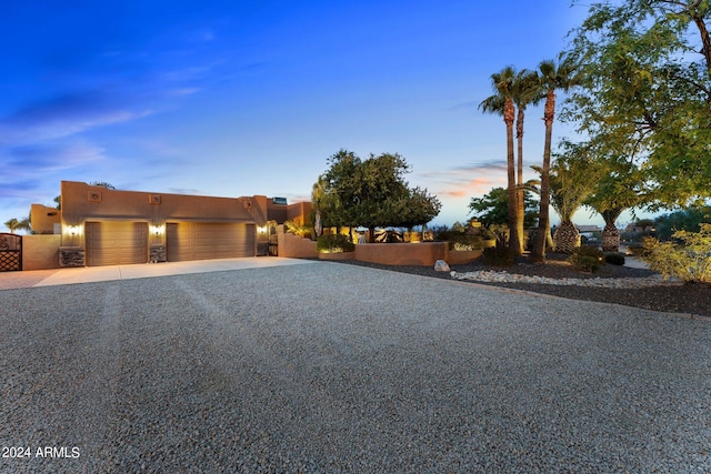 pueblo revival-style home with a garage