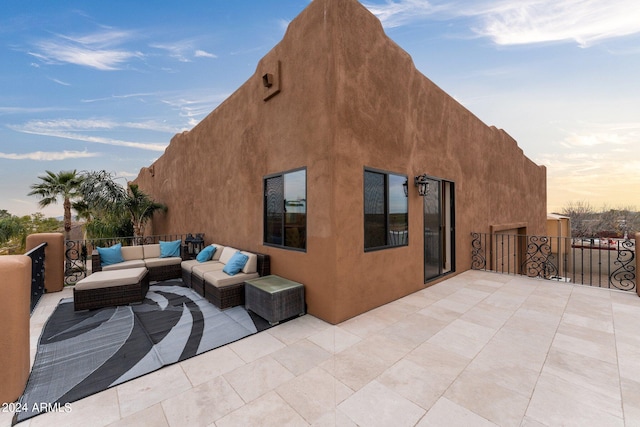 patio terrace at dusk featuring an outdoor living space