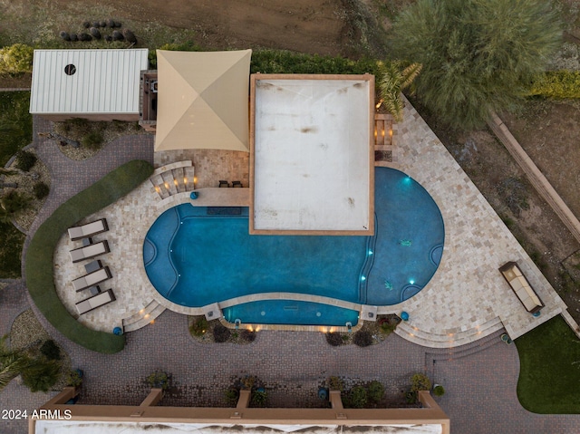 view of swimming pool with a hot tub and a patio area