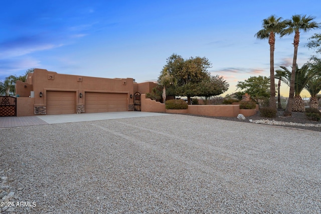 property exterior at dusk featuring a garage