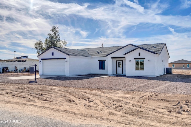 view of front of home featuring central AC and a garage