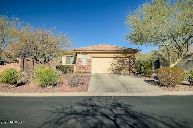 view of front of property with fence, an attached garage, stucco siding, concrete driveway, and a tile roof