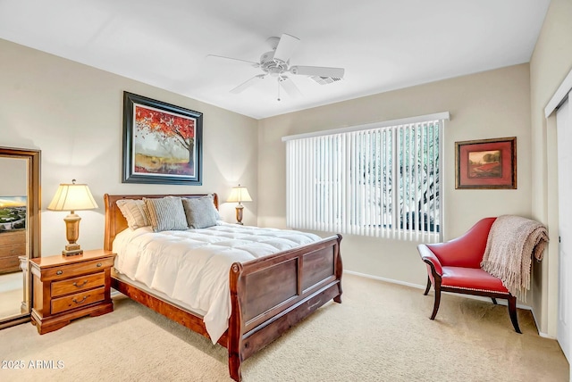 bedroom featuring a ceiling fan, light colored carpet, baseboards, and a closet