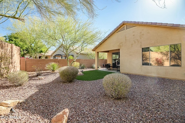 view of yard featuring a fenced backyard and a patio area