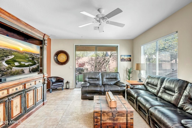 living area featuring light tile patterned floors and ceiling fan